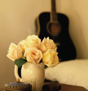 White roses beside bed